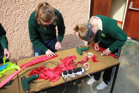 Arts in education - group make large dragon float with Artastic